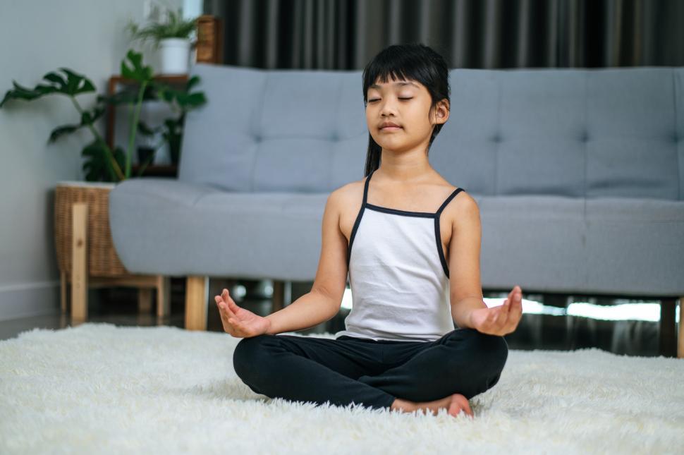 Free Image of girl doing yoga in room on white carpet 