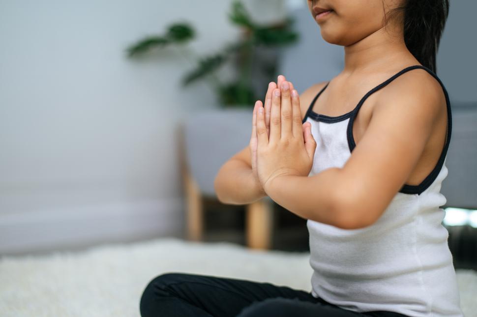 Free Image of girl doing yoga in room on white carpet 