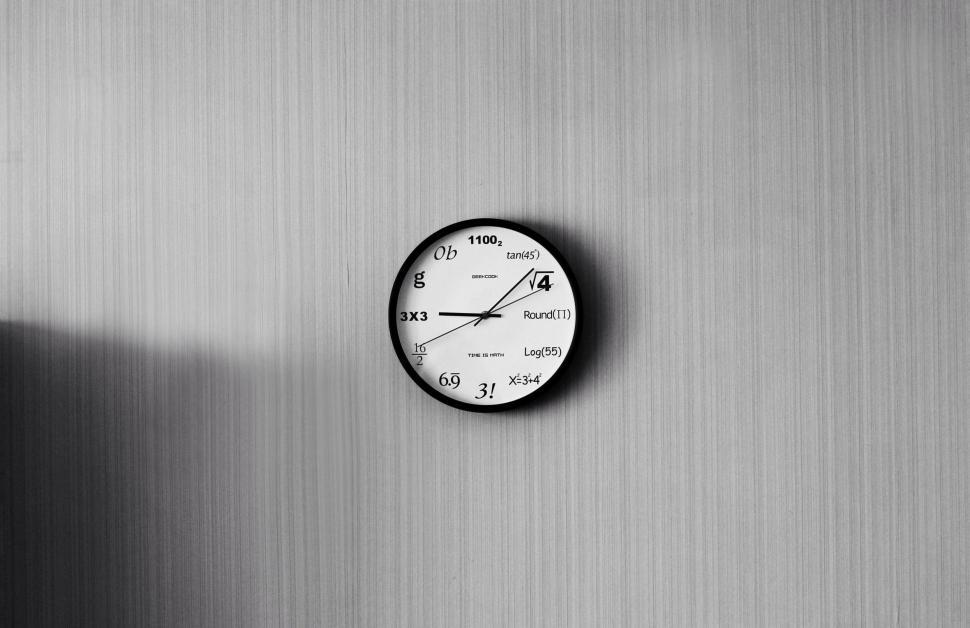 Free Image of Math-themed wall clock with various mathematical symbols 