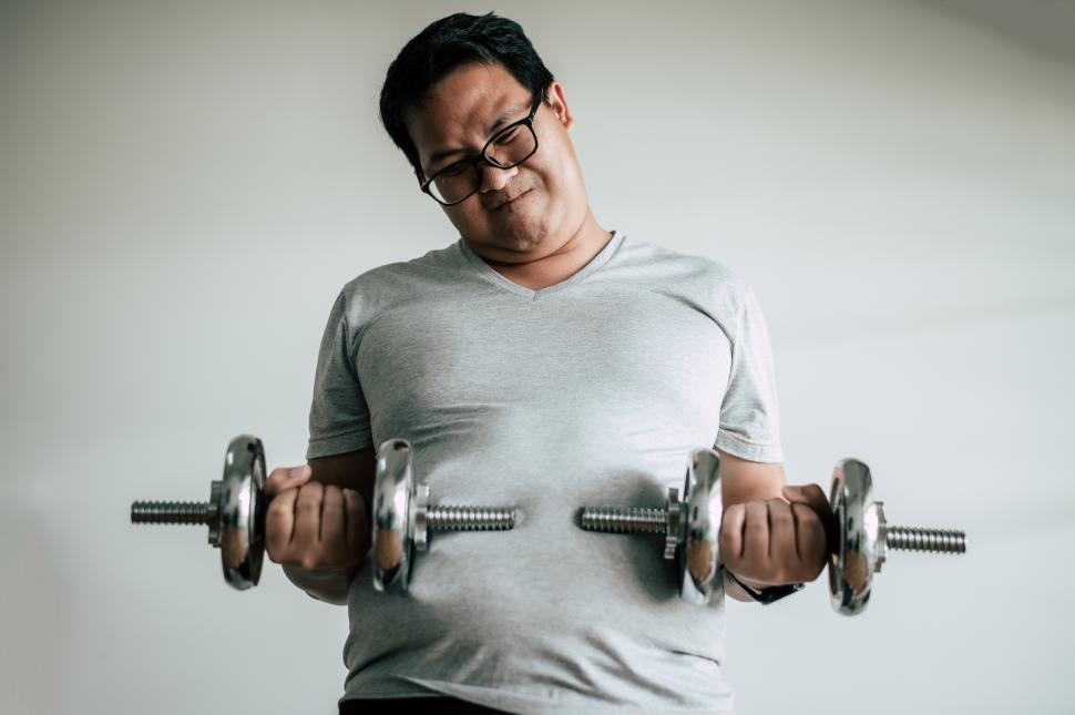 Free Image of Funny fat man workout with dummbell 