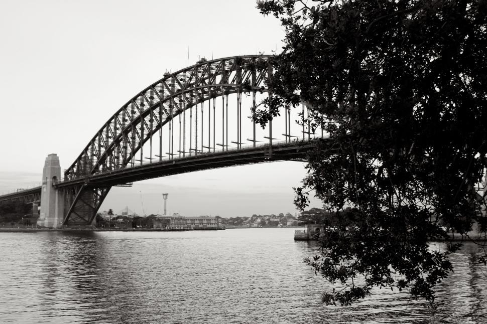 Free Image of Sydney Harbor Bridge over water in grayscale photo. 