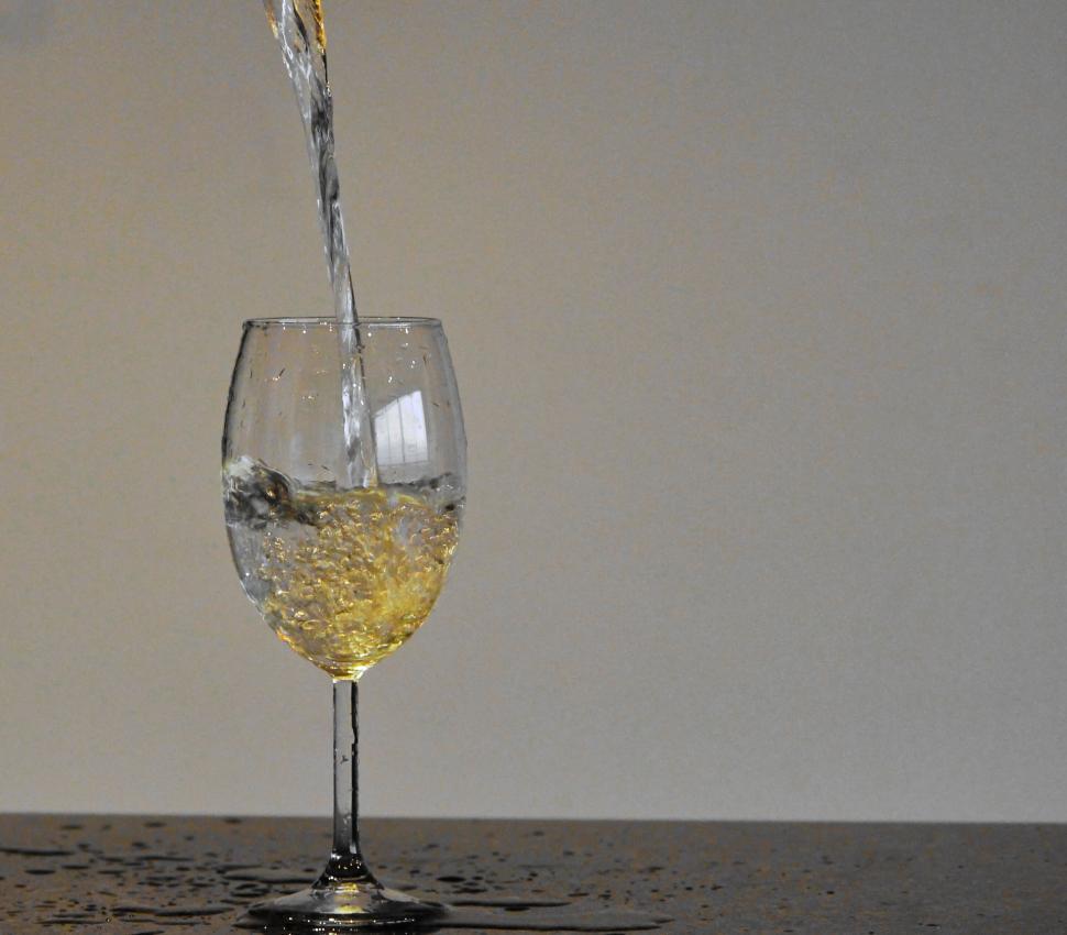 Free Image of Clear water pouring into glass in a minimalist photo. 