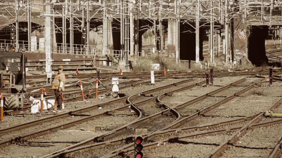 Free Image of Railway tracks extending towards a distant urban tunnel 