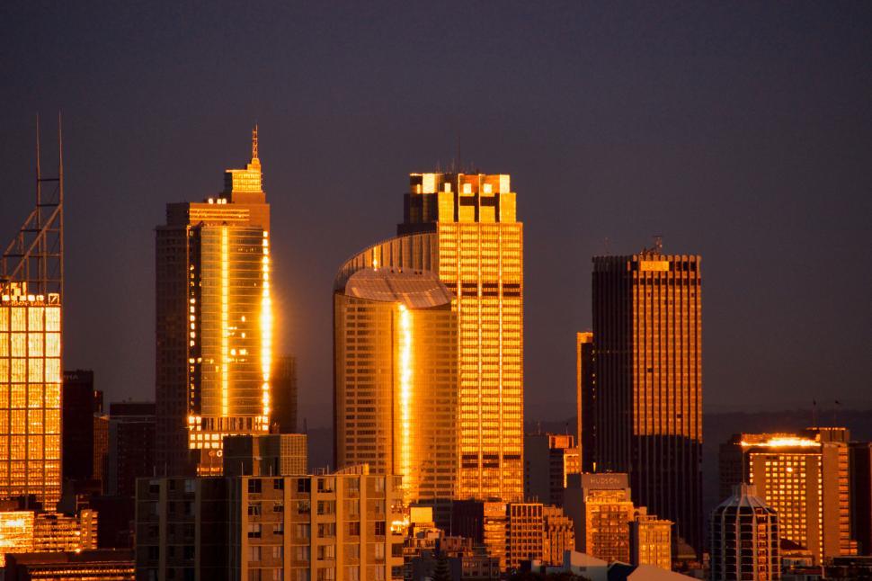 Free Image of Golden Sydney skyscrapers reflecting sunlight in urban landscape. 