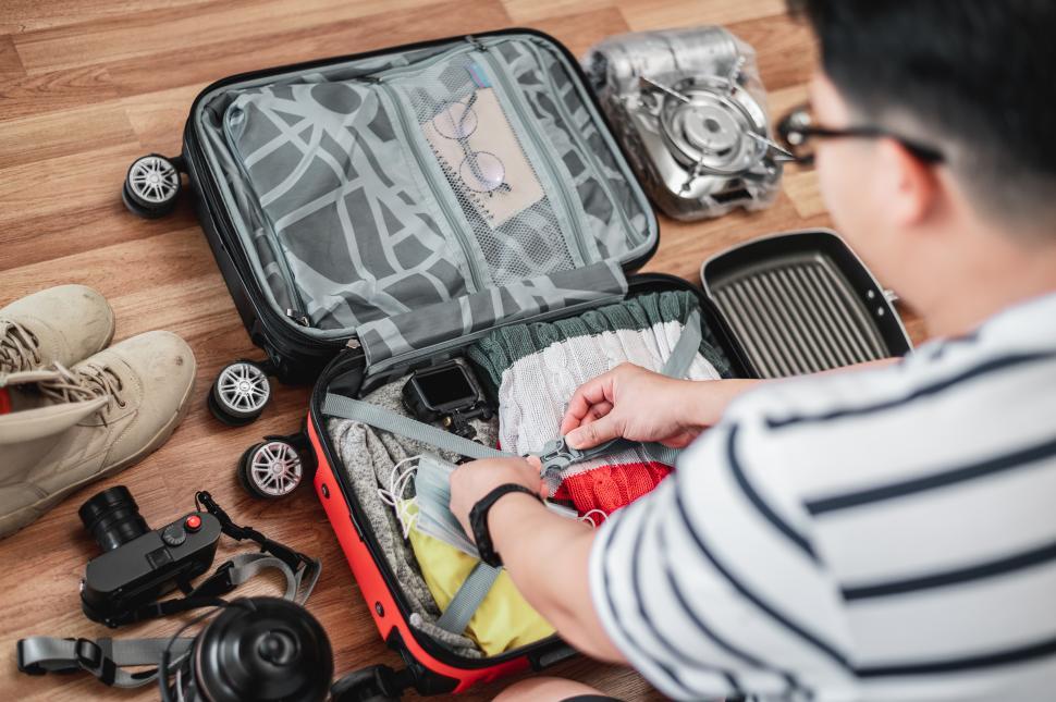 Free Image of Preparing suitcase for summer vacation trip 