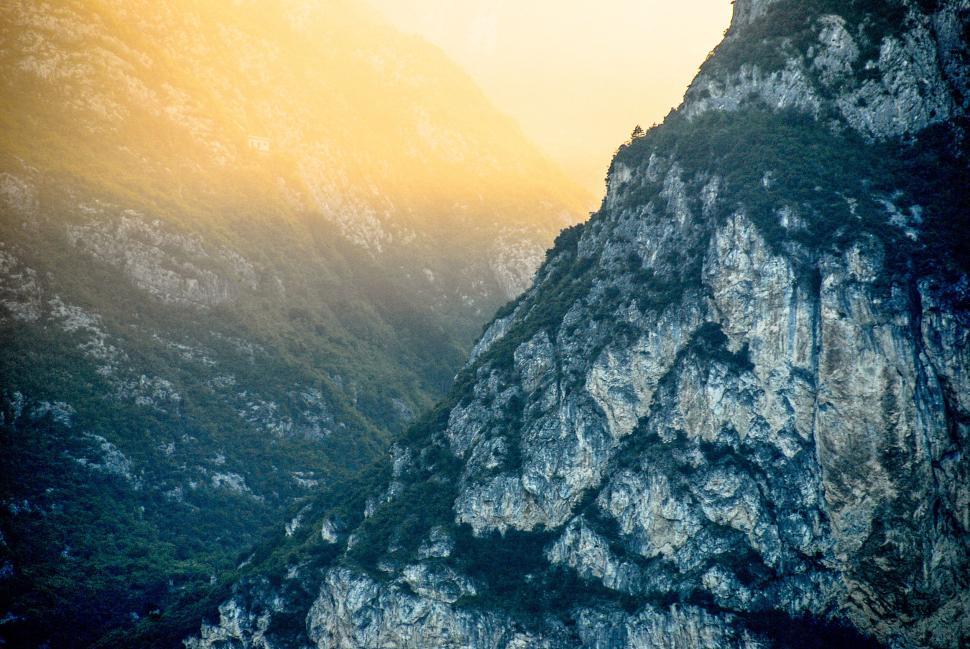 Free Image of Misty mountain with rugged cliffs and lush green foliage 