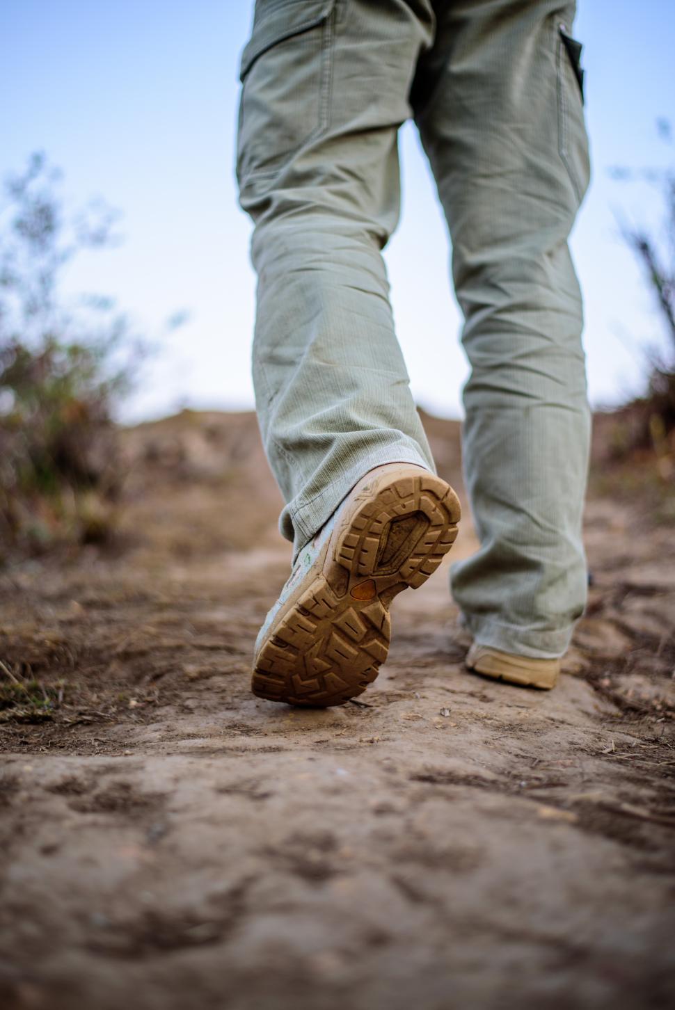 Free Image of Close-up feet Hiker man wearing boots to travel walking in a green forest 