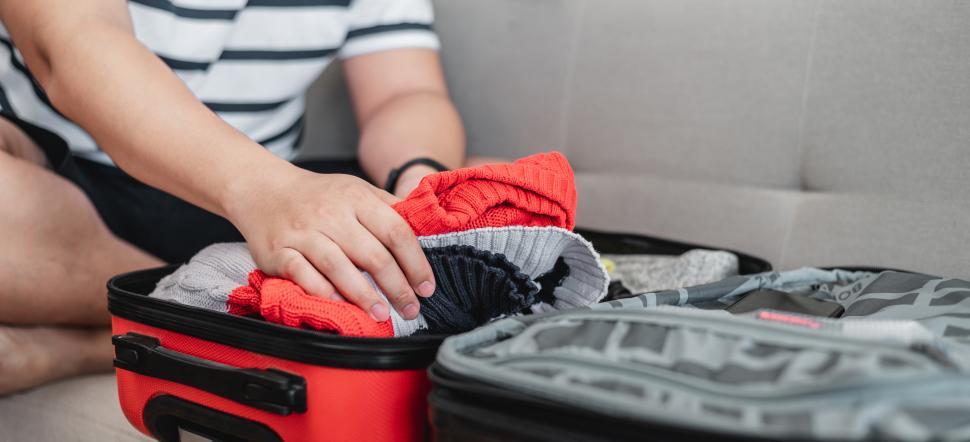 Free Image of Preparing suitcase for summer vacation trip 