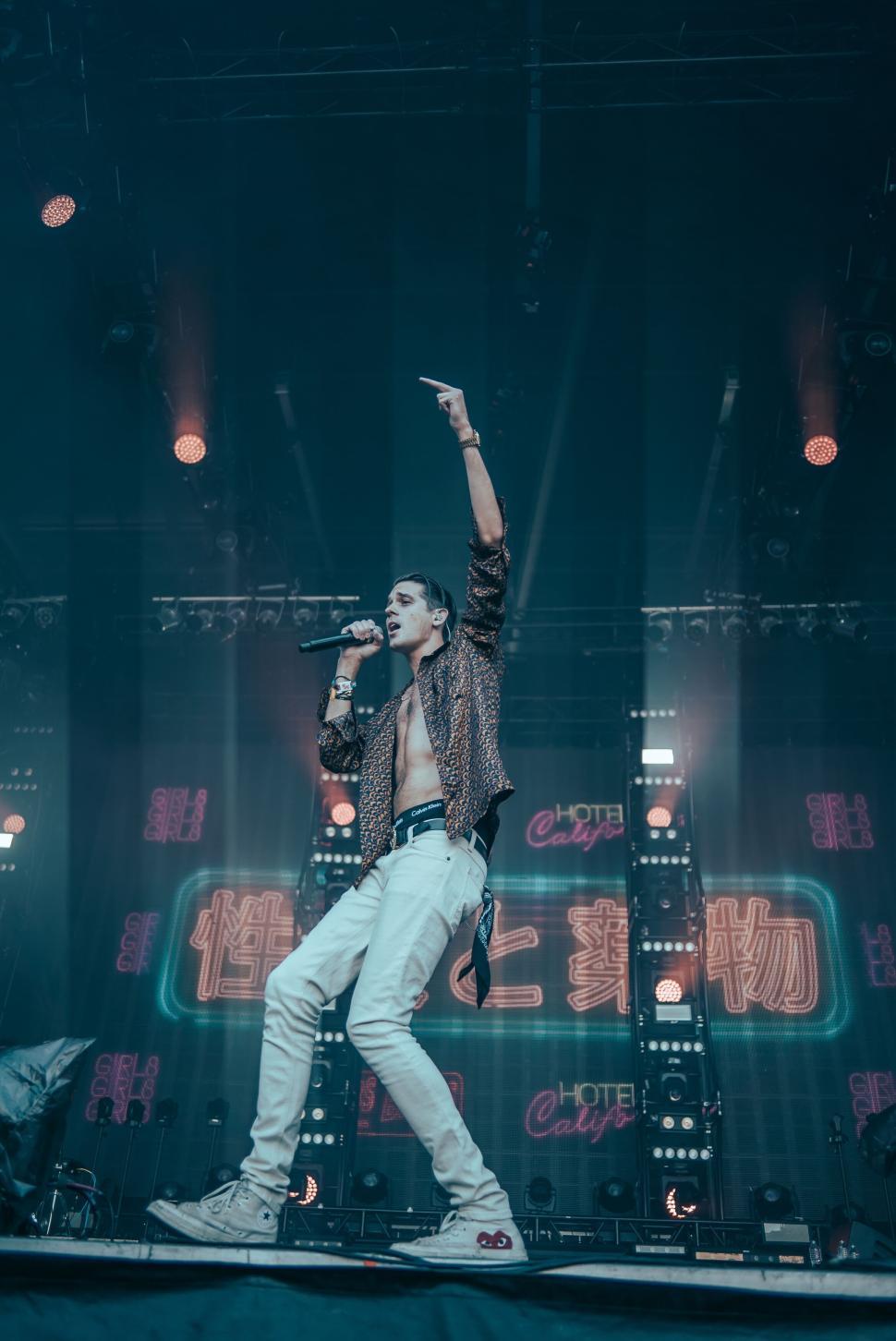 Free Image of Young male singer performing energetically on stage. 