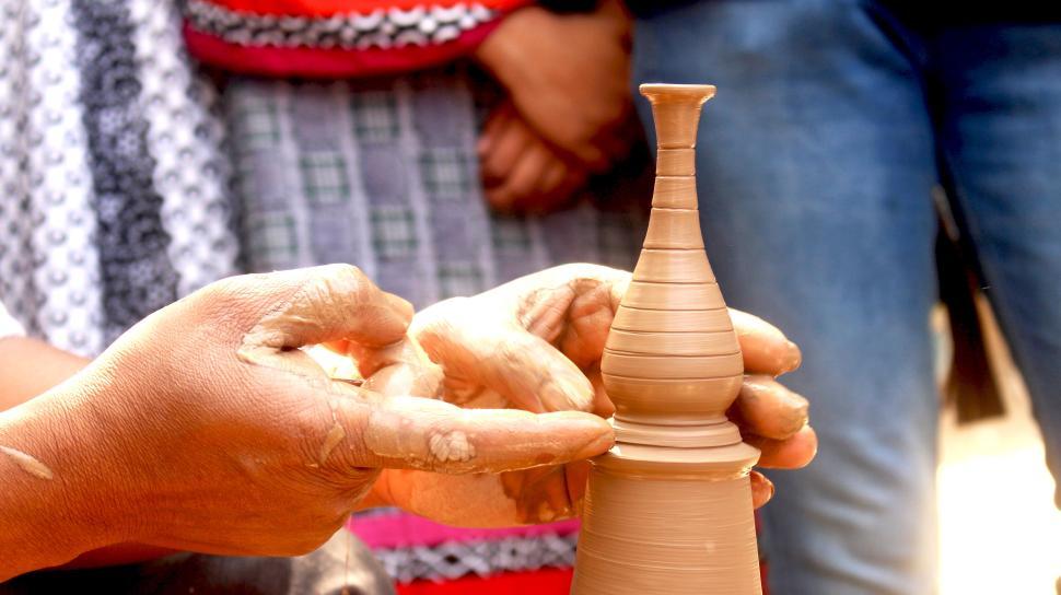 Free Image of Hands shaping pottery on a wheel in a pottery workshop. 