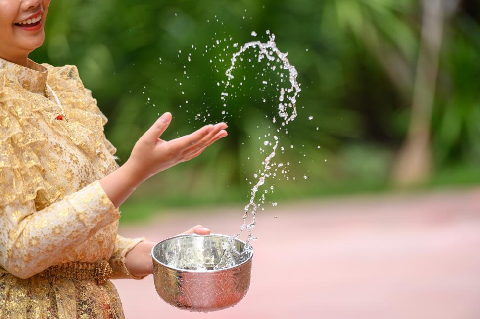 Free Image of Female hands holding water bowl on Songkran festival 