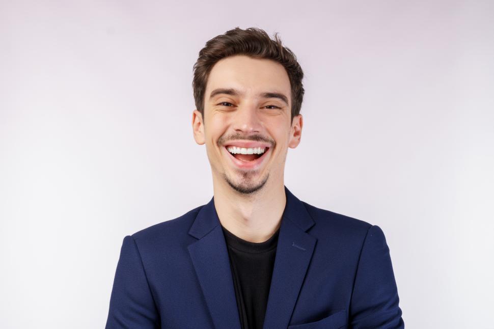 Free Image of Portrait of a cheerful businessman smiling and looking at camera over white background 