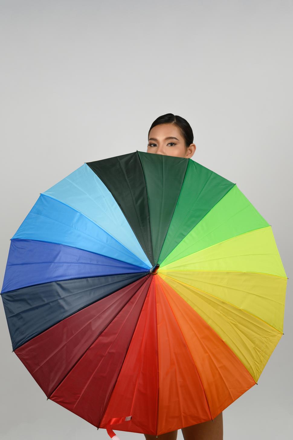 Free Image of Woman celebrating diversity with a rainbow umbrella at a pride event 