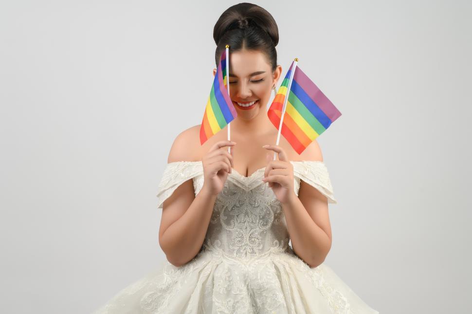 Free Image of Young bride with rainbow pride flags on white background 