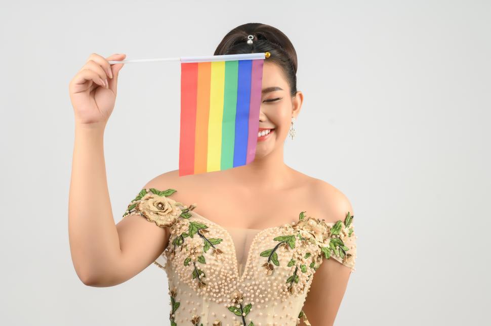 Free Image of Young asian beautiful bride with rainbow flag on white background 