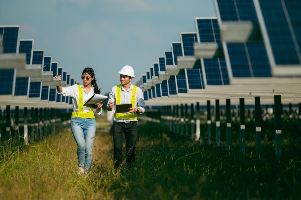 Free Image of Asian Inspectors walking operation in commercial solar farm 