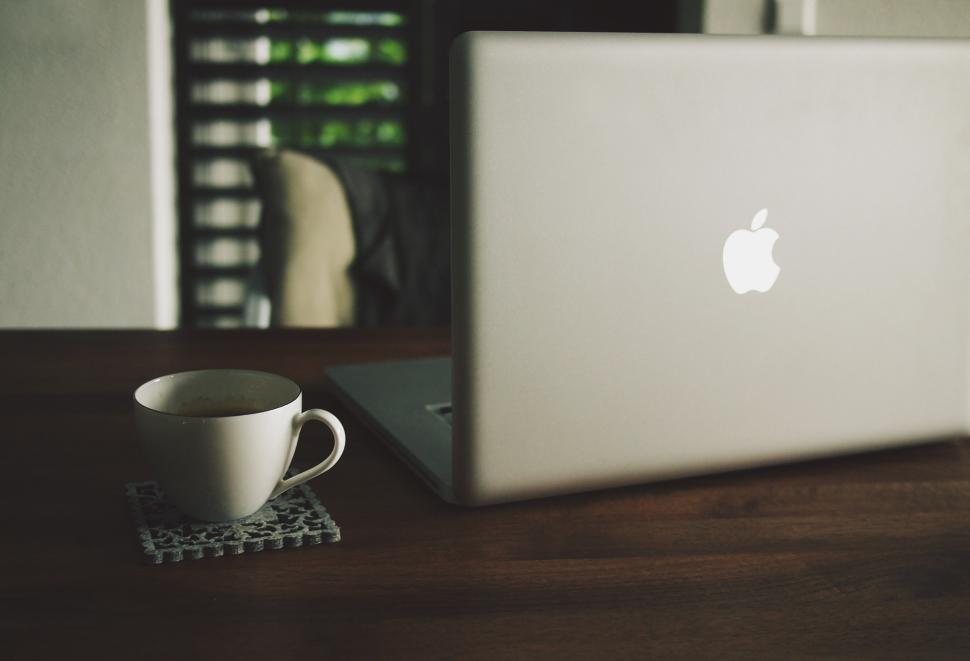 Free Image of Cozy workspace with laptop and coffee cup on wooden table 