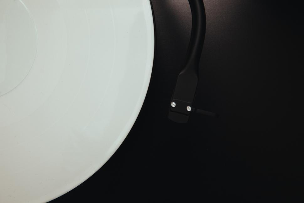 Free Image of Vinyl record player on a black surface in a cozy setting 