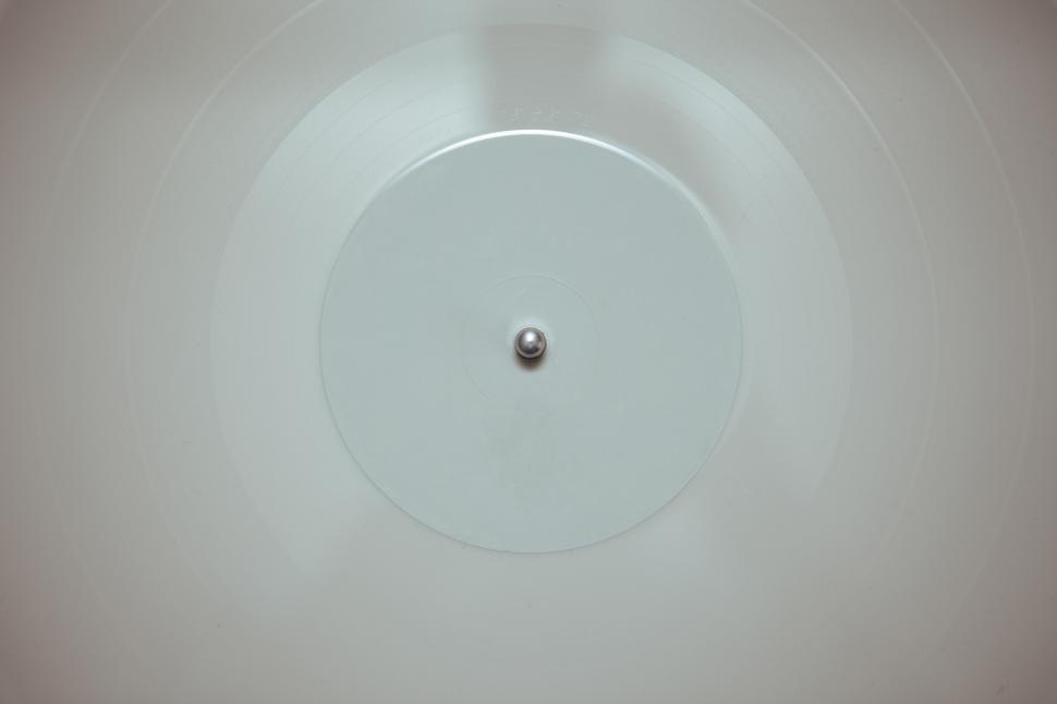 Free Image of Vinyl record spinning on turntable with metallic spindle 