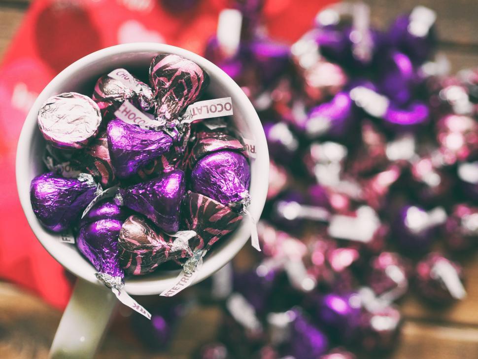 Free Image of Colorful chocolate candies in a mug on a wooden table 