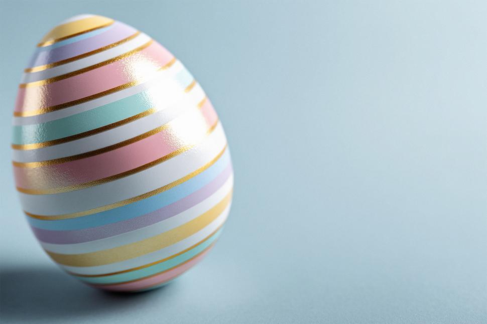 Free Image of Colorful striped egg stands on pastel background 