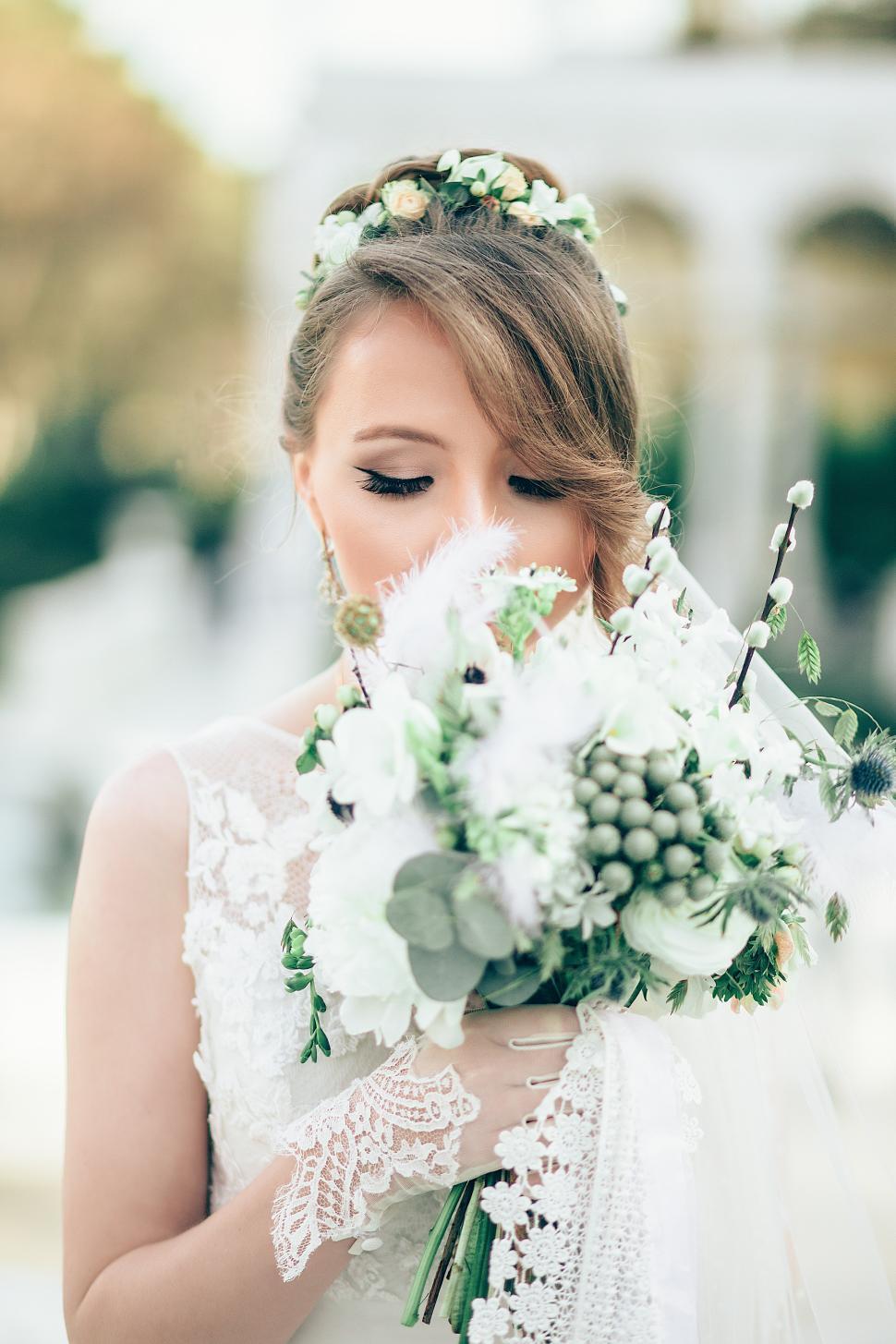 Free Image of Bridal portrait with bouquet in blooming garden setting 