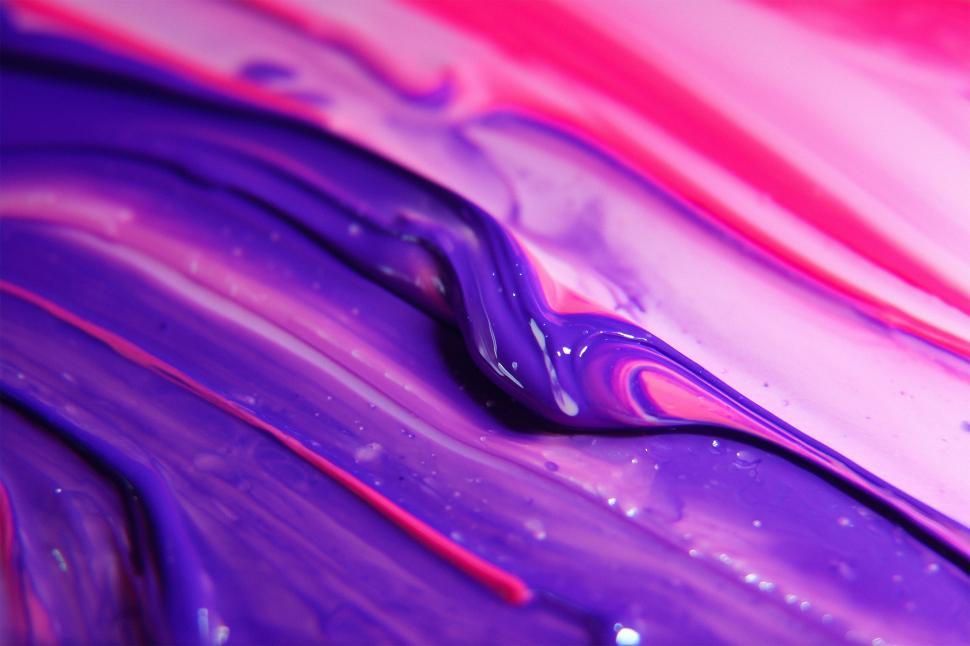 Free Image of Swirls of purple and pink paint on a canvas background 