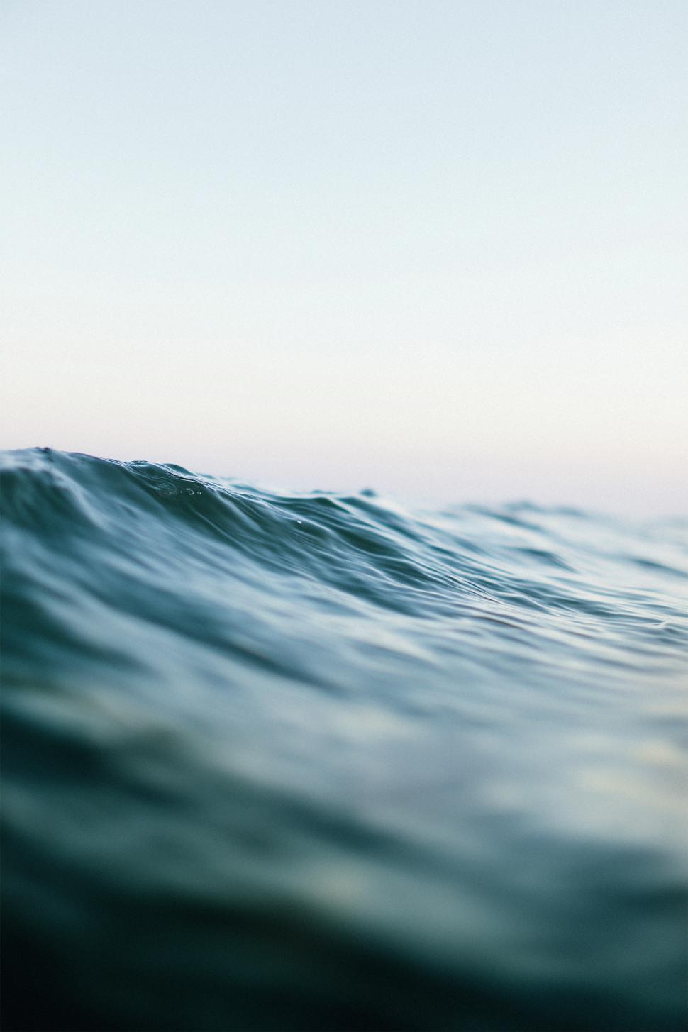 Free Image of Calm ocean waves rolling gently at sunrise 