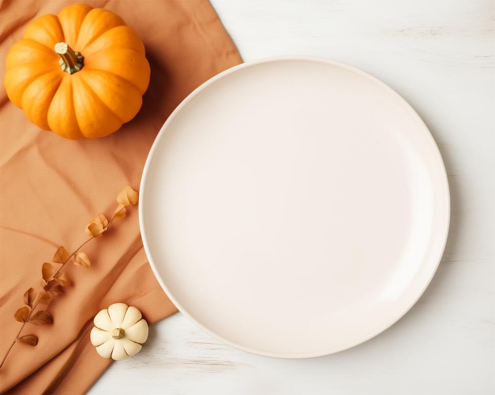 Free Image of Table setting with pumpkins and a blank plate for autumn festivities 