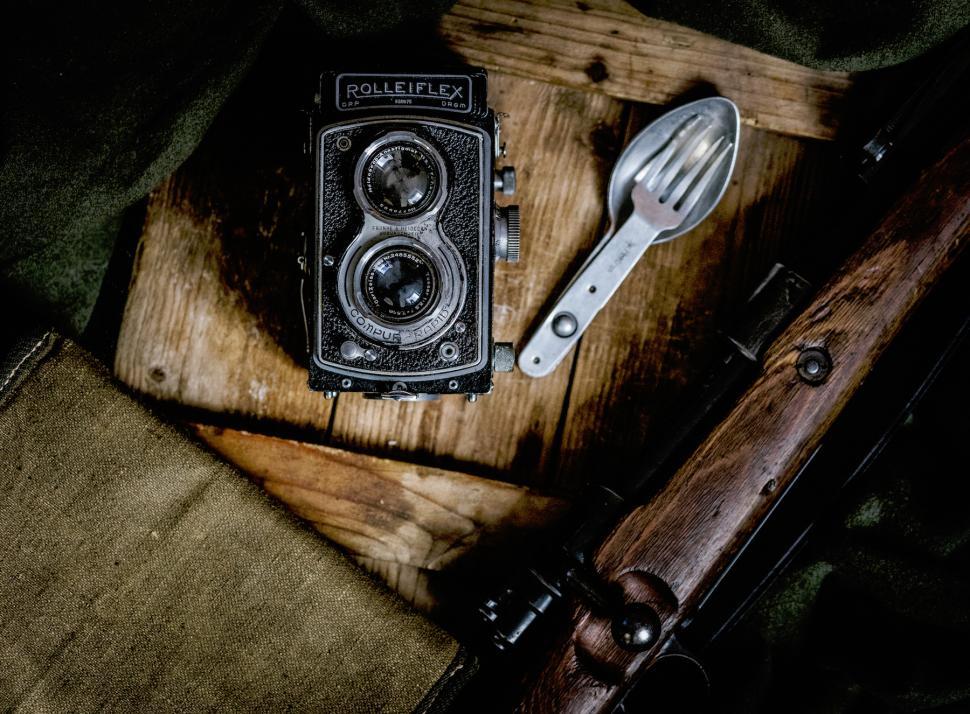 Free Image of Vintage camera and utensils on wooden surface in natural light 