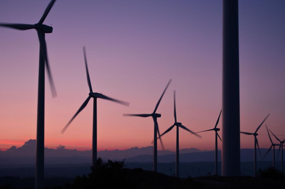 Free Image of Wind turbines against a sunset backdrop in an eco-friendly landscape 