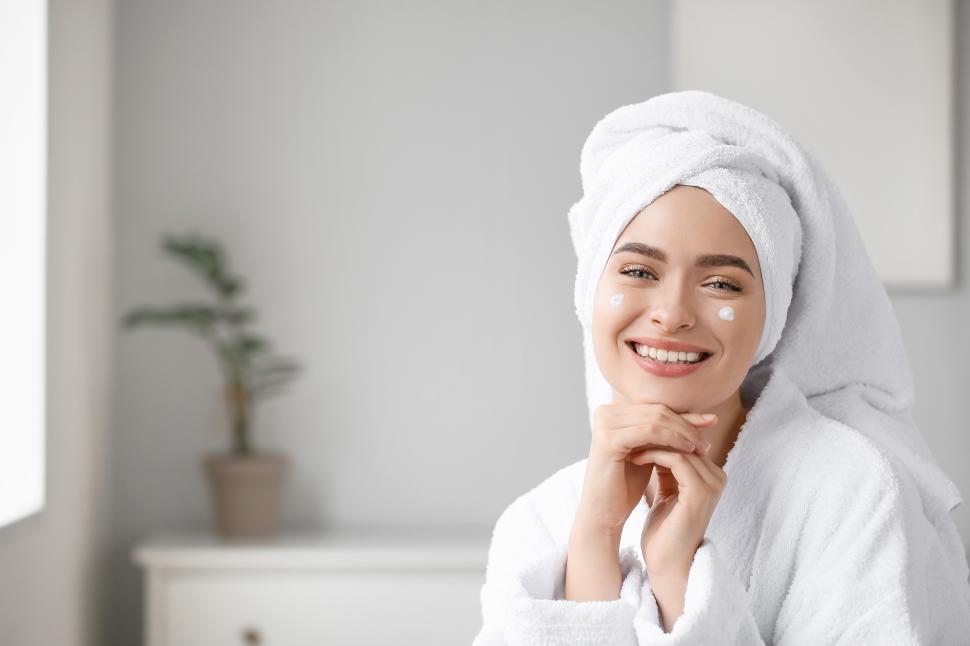Free Image of Woman enjoying skincare routine in cozy bathroom 
