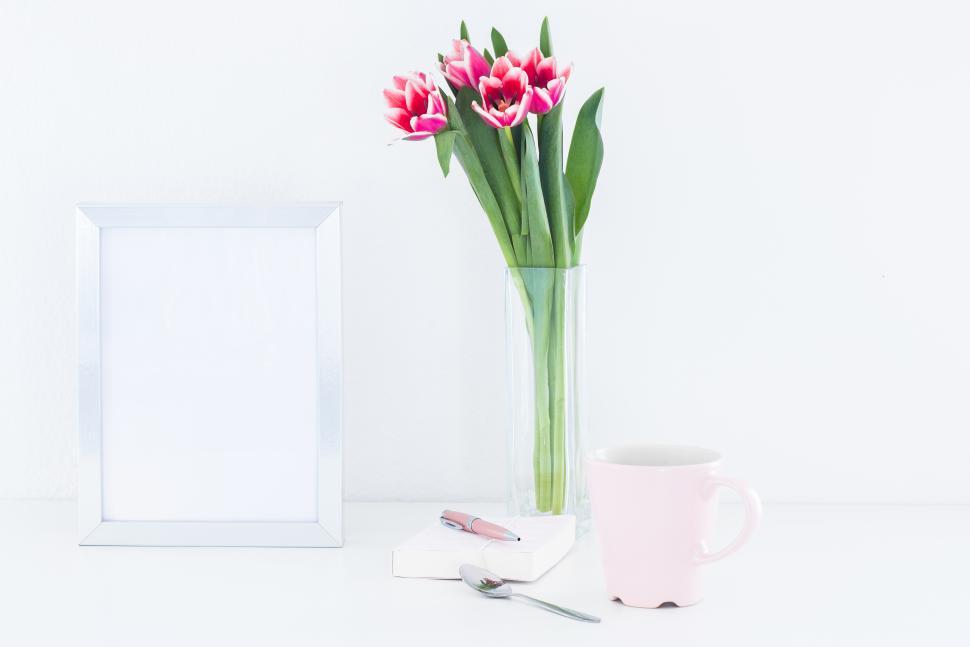 Free Image of Fresh tulips and a coffee cup on a white table 