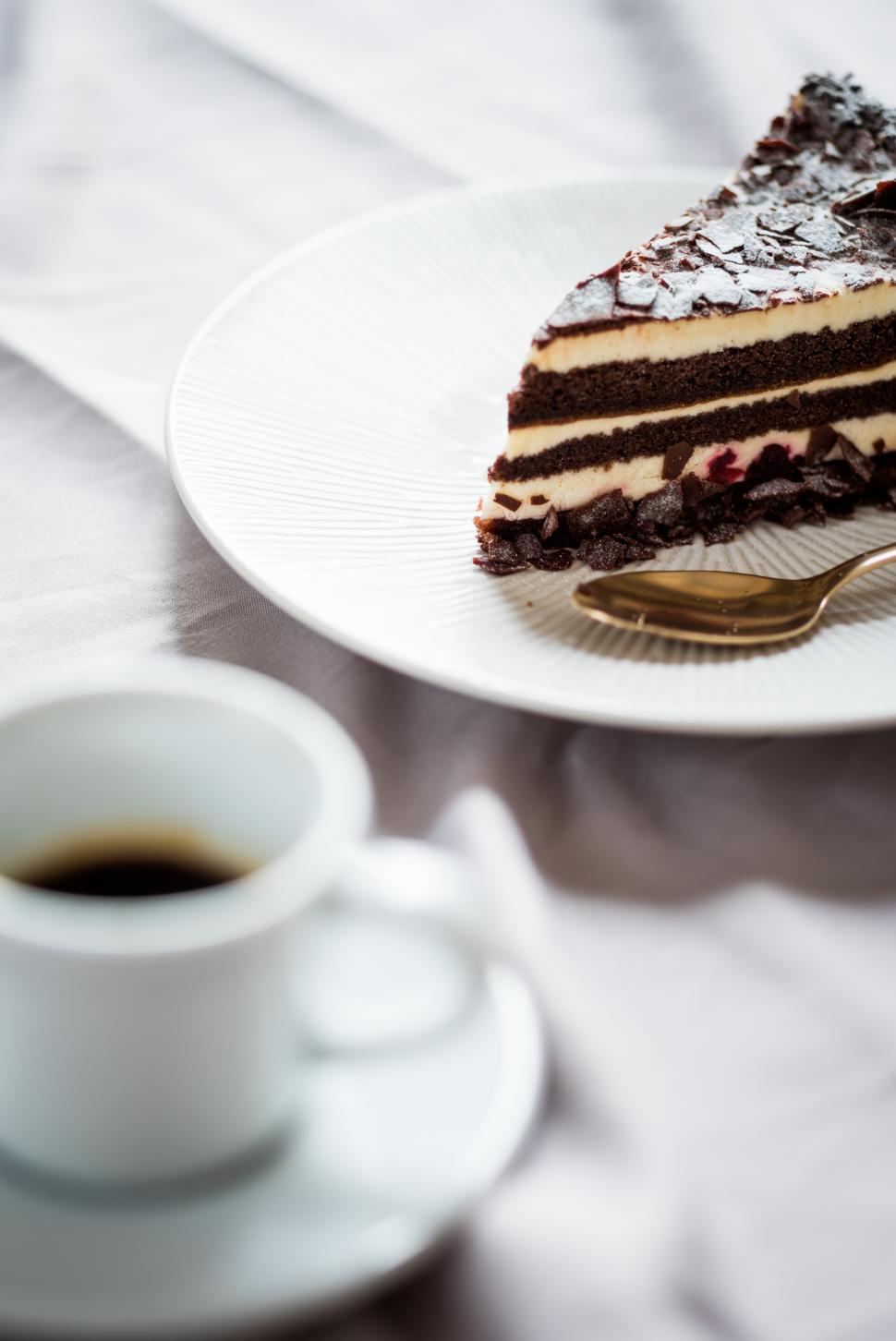 Free Image of Delightful chocolate cake with coffee in a cozy setting 
