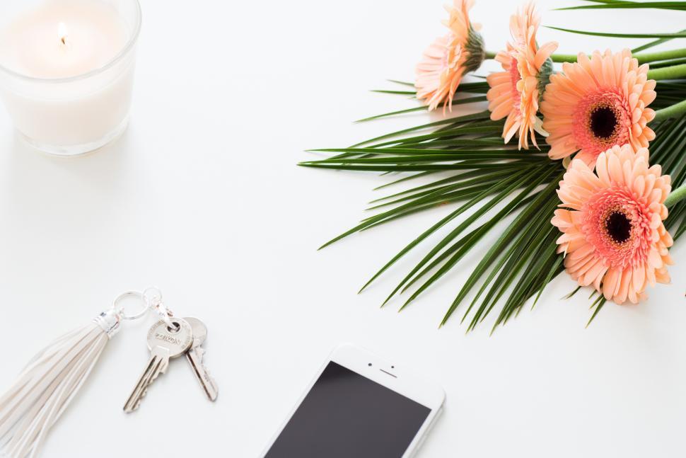 Free Image of Decorative arrangement of flowers and essentials on a table 