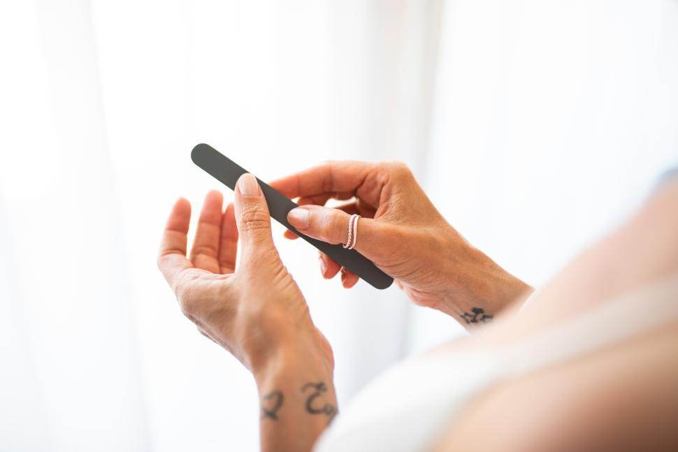 Free Image of Woman filing her nails 