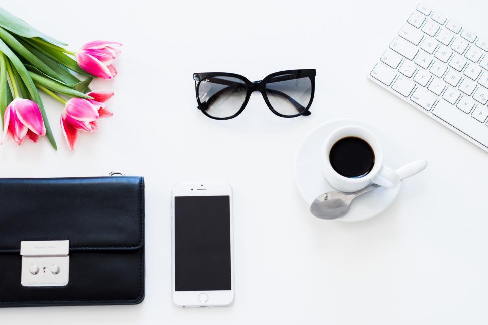 Free Image of Workspace arrangement with flowers and coffee highlights 
