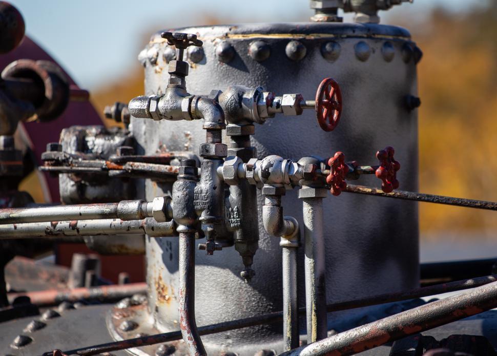 Free Image of Vintage steam engine valve system with intricate metal pipes and fittings 