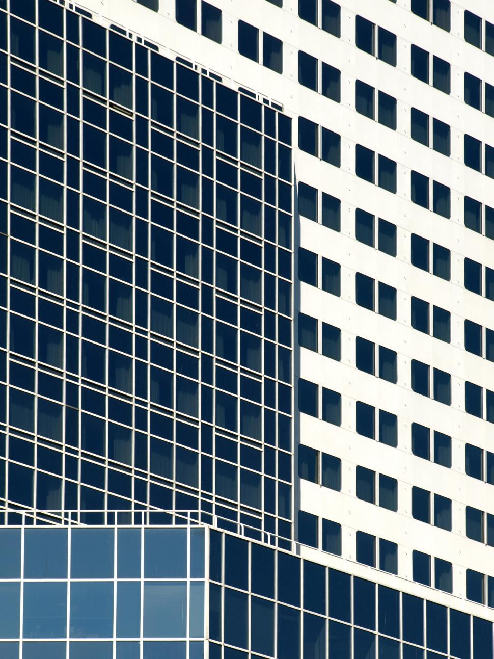 Free Image of Modern architectural design features reflective glass panels on city buildings 