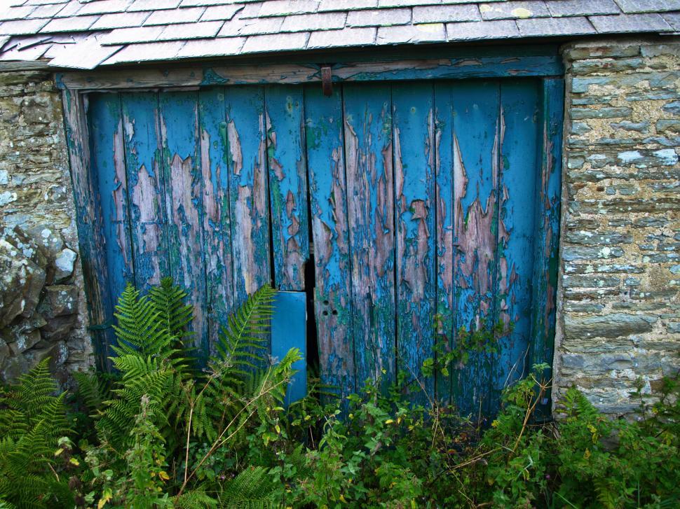 Free Image of Old weathered blue door in a rustic stone building 