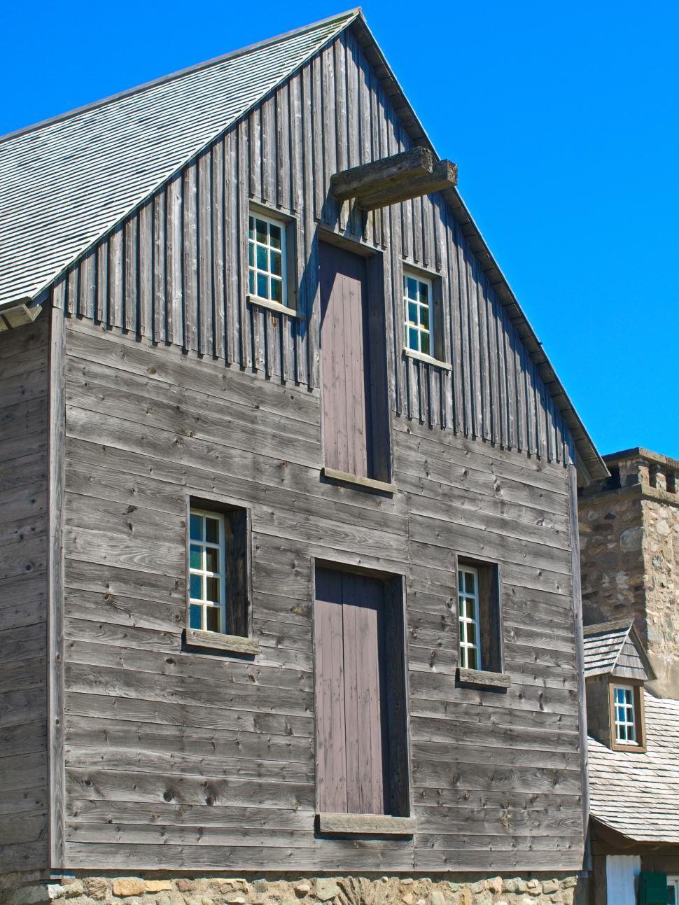 Free Image of Historic wooden building under clear blue sky in a rural setting 