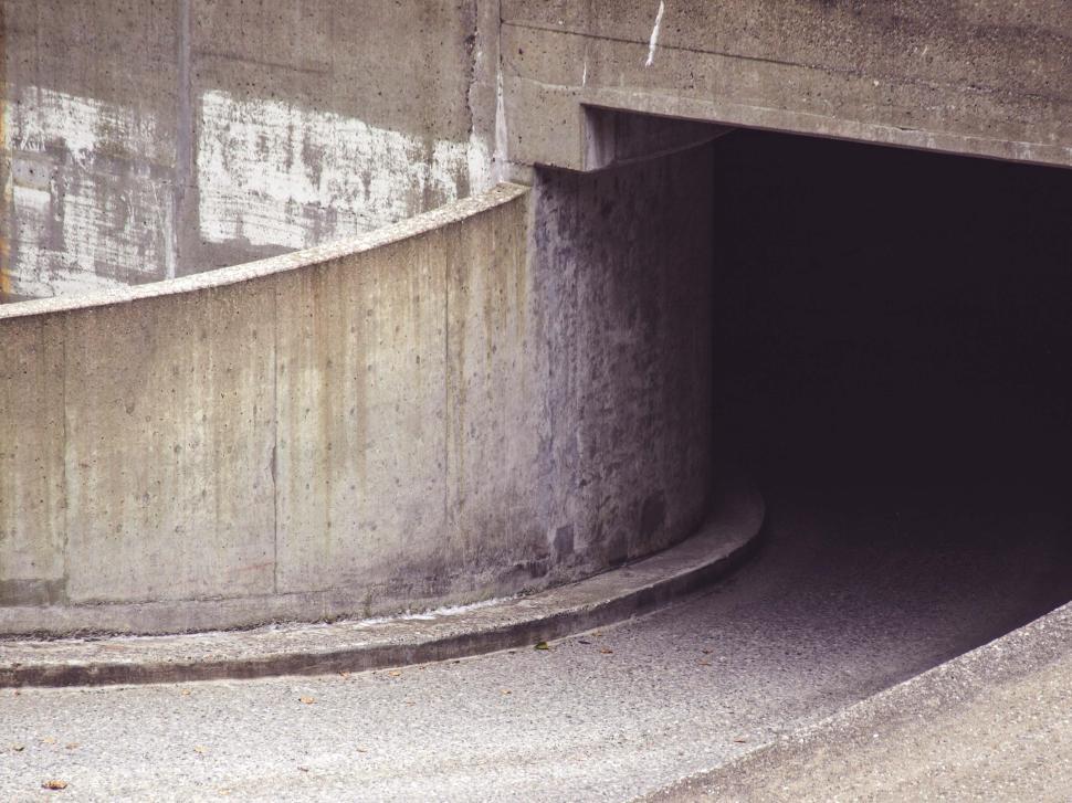 Free Image of Curved concrete structure leading into a dark tunnel at urban location 