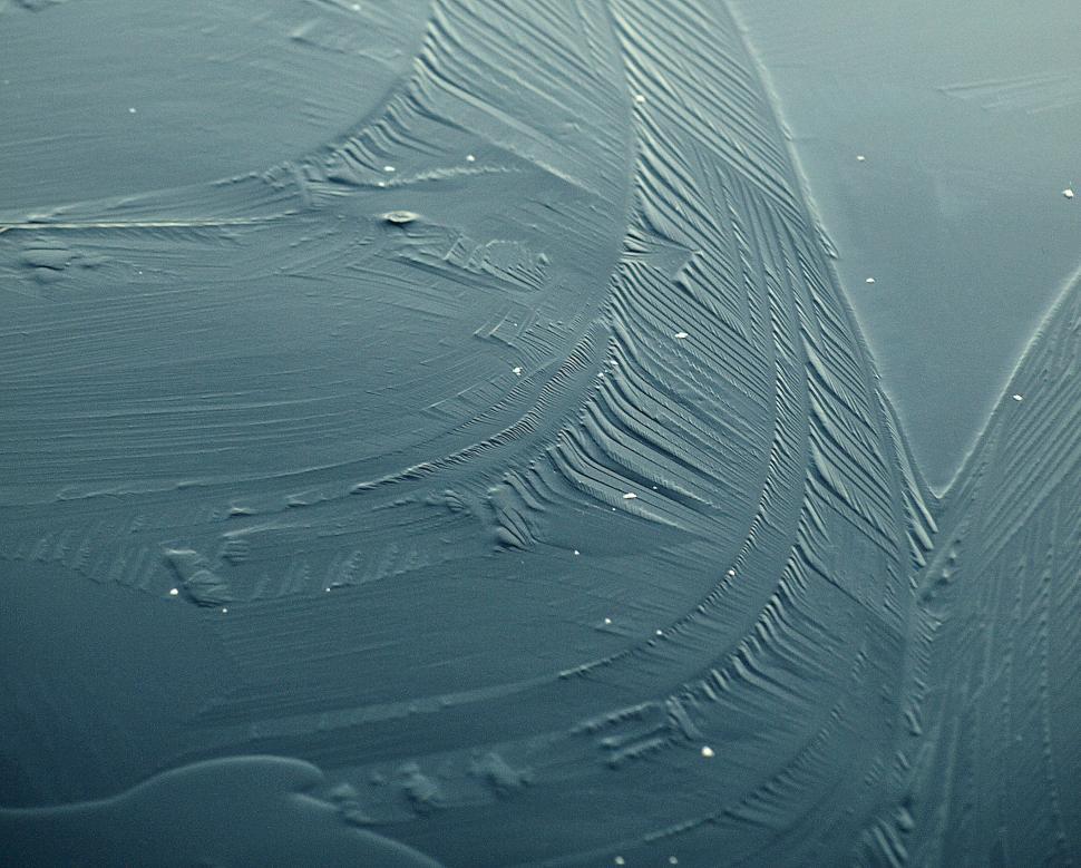 Free Image of Textured surface of dark paint with scratch patterns from application process 
