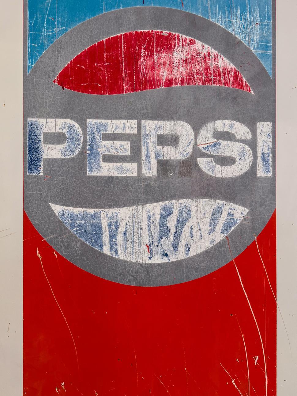 Free Image of Vintage Pepsi billboard showcasing faded logo in urban setting 