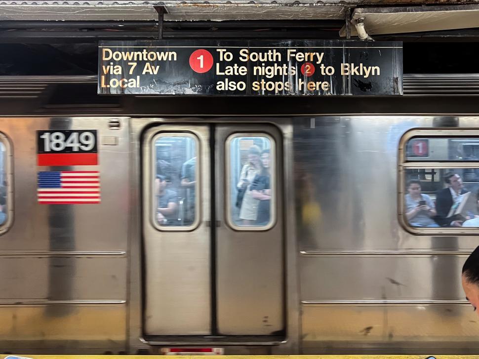 Free Image of New York City Subway train arriving at busy station 