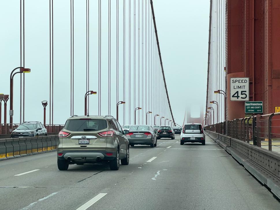 Free Image of Cars traverse the Golden Gate Bridge in San Francisco on a foggy day 