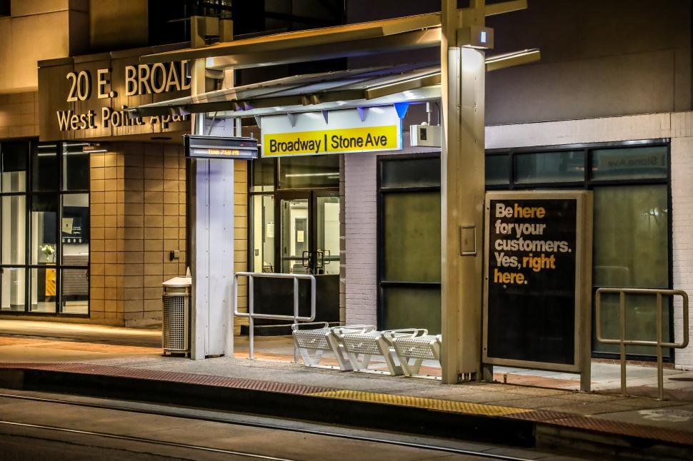 Free Image of Nighttime view of Broadway and Stone Avenue transit station with waiting area 
