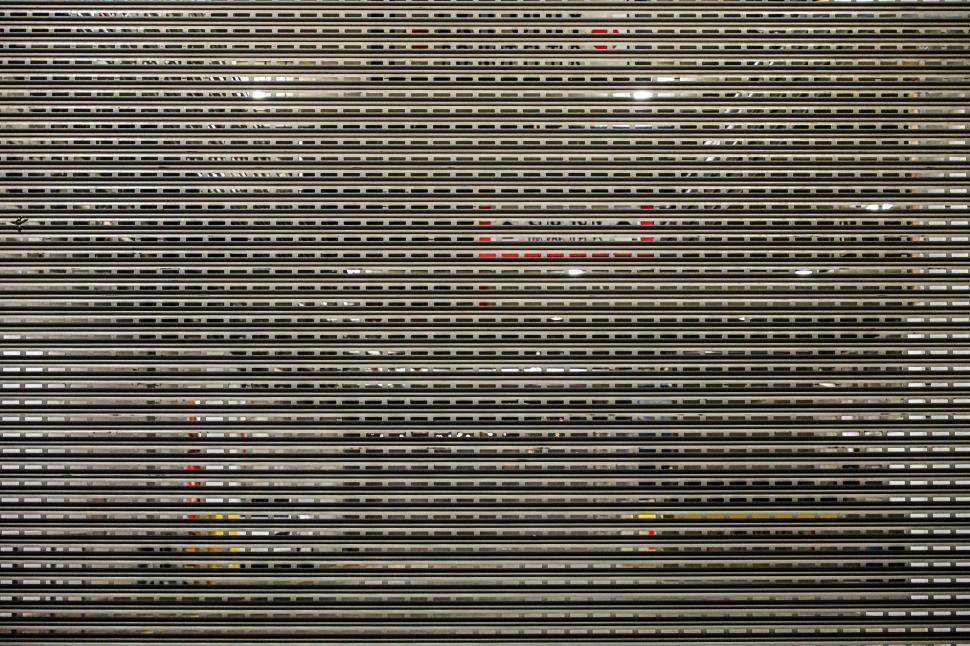 Free Image of Metal shutters close at a storefront during nighttime in an urban setting 