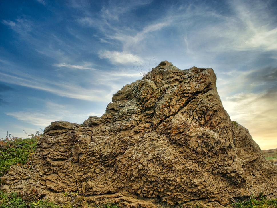 Free Image of Unique rock formation under a dynamic sky at sunset in a natural landscape 