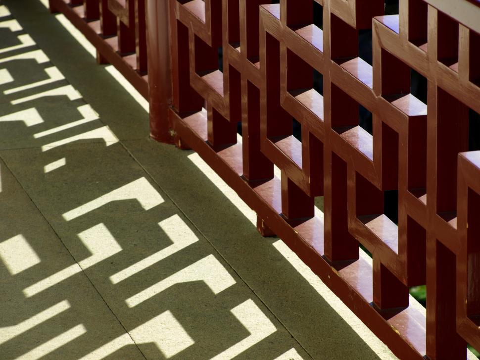 Free Image of Elegant shadow patterns created by wooden railing in bright sunlight 